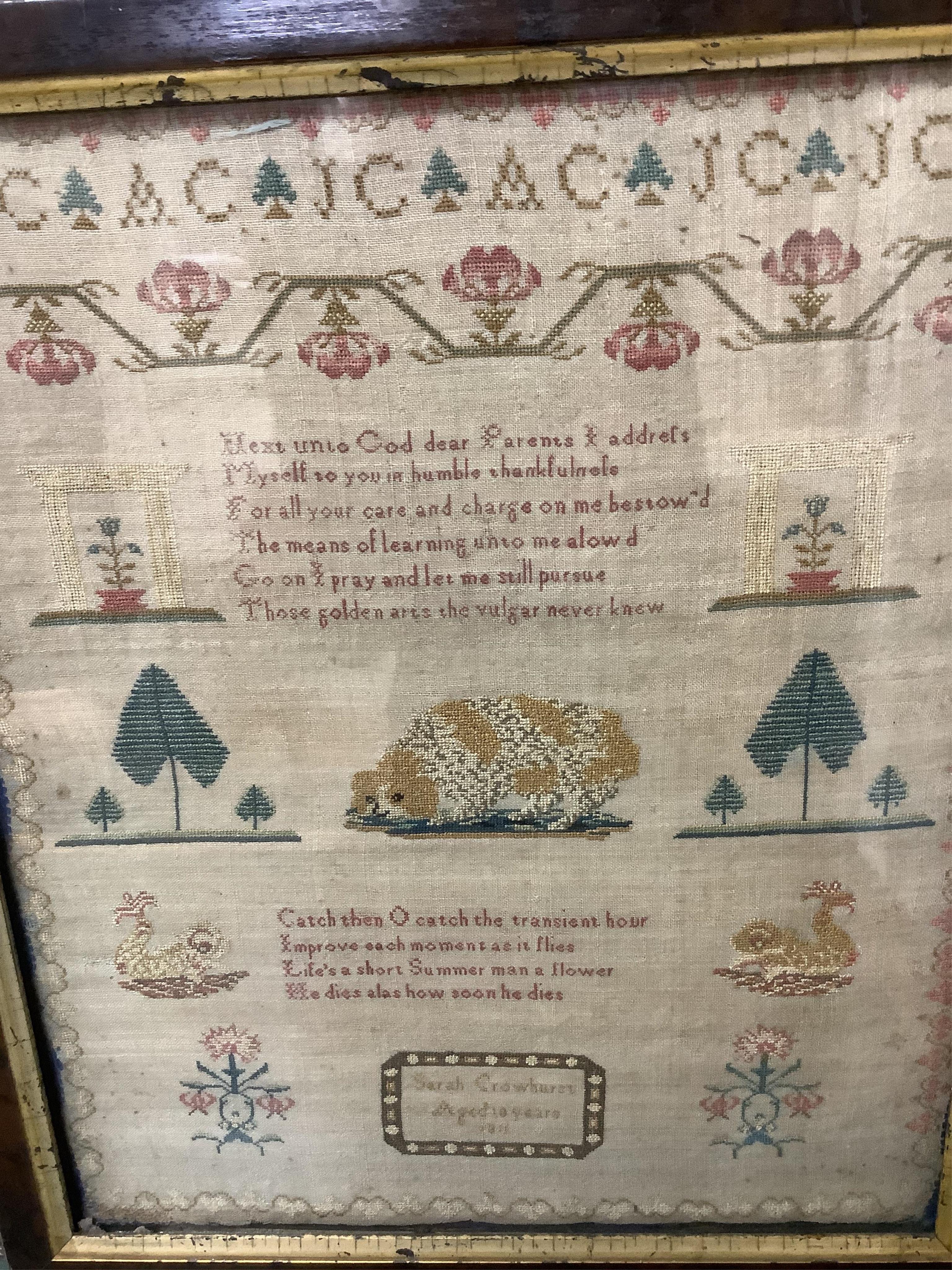 An early 19th century framed sampler by Sarah Crowhurst aged 10 years, dated 1811. Very finely embroidered, on fine linen, with a line of alphabet, then a religious verse and a large central spaniel motif between stylist